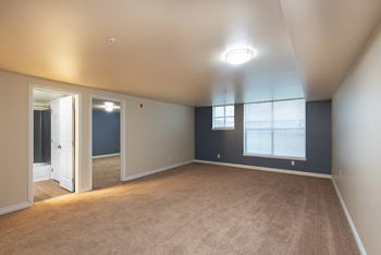 An empty living room with blue walls and a window